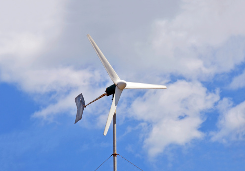 Wind power turbine on blue sky background