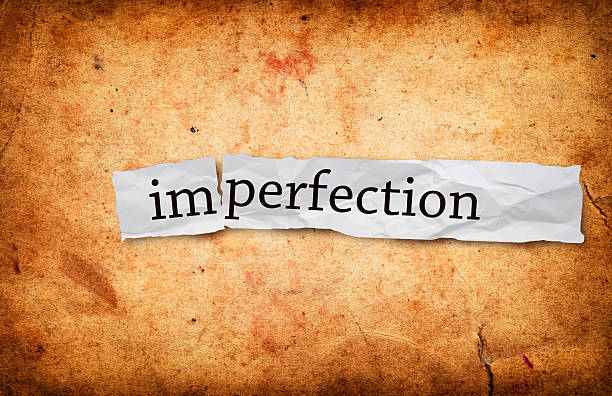 istock Imperfection title on old paper 463728315