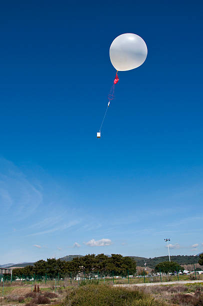 weather balloon weather balloon in the blue sky weather balloon stock pictures, royalty-free photos & images