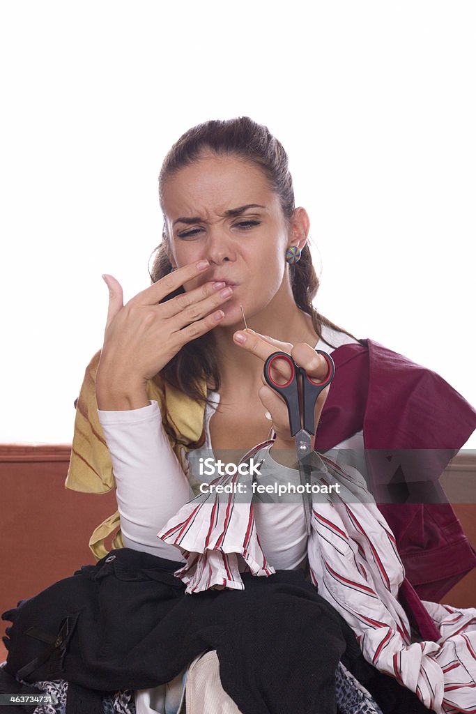 girl tailor stabs at needle girl tailor with scissors stabs at needle Adult Stock Photo