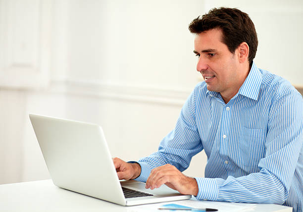 istock Attractive adult businessman using his laptop 463742173