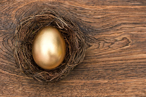 istock golden easter egg in nest over wood 463743657