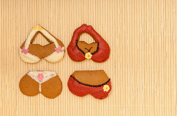 istock Funny colorful bikini shape gingerbread cakes cookies on bamboo mat 463745065