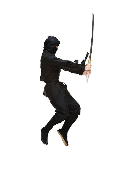 istock Side view of ninja jumping with sword 463750345
