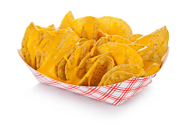 Nachos Nachos with just cheese, in a standard restaurant paper tray. nacho chip stock pictures, royalty-free photos & images
