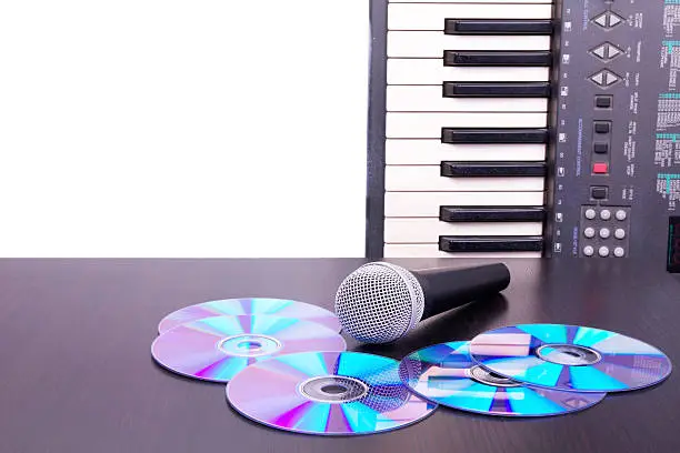 Photo of Microphone,cd discs and electronic keyboard