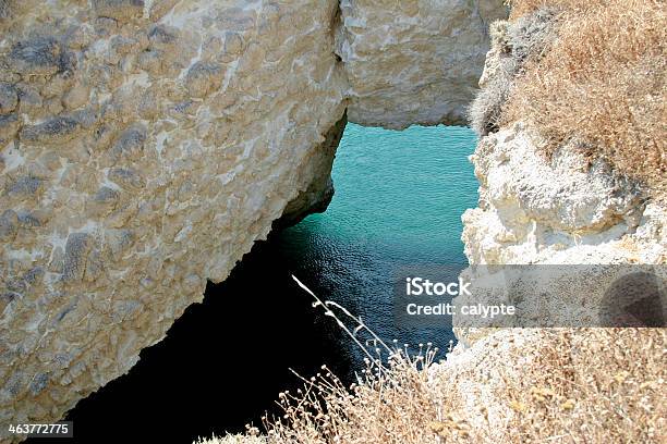 Glance At An Inlet Through A Rockformation In Milos Greece Stock Photo - Download Image Now