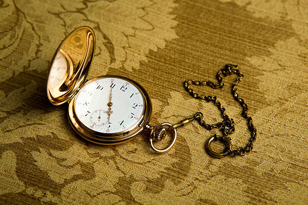 istock pocket watch on gold cloth 463781307