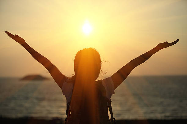 istock cheering hiking woman sunrise seaside 463785425