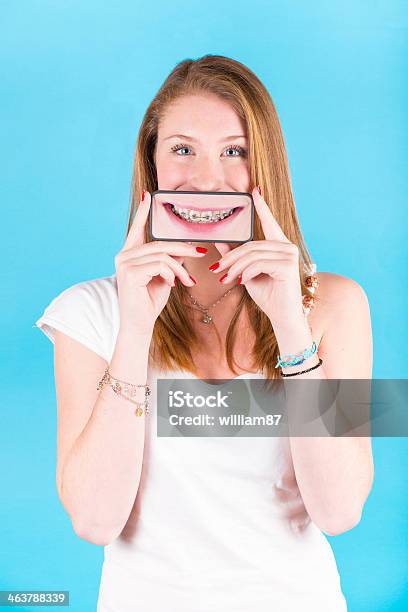 Smiling Girl Holding Smartphone Stock Photo - Download Image Now - Dental Braces, Dental Health, Device Screen
