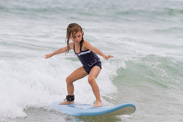Six year old girl surfing.