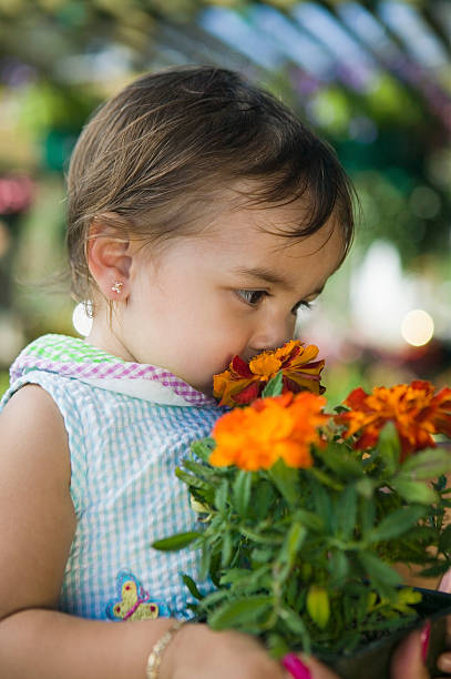 istock Girl Smelling Marigolds 463801953