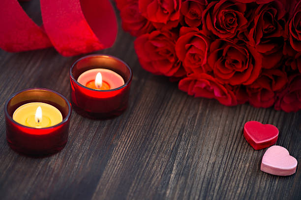 istock Red roses and candles on wooden background with copy space 463803877