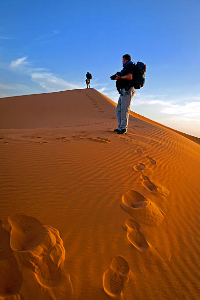 istock Men on Erg Chebbi Sand Dune at Sunrise, Morocco, Africa 463812719