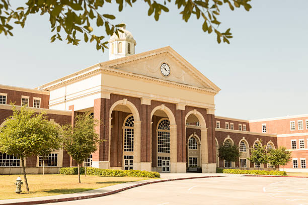 Education: College or high school campus entrance. Building. New, modern high school building entrance and driveway. Red brick construction.  schoolhouse stock pictures, royalty-free photos & images