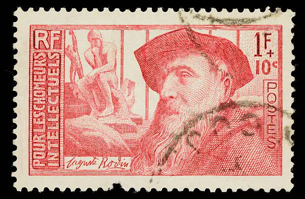 1938 French postage stamp with an image of Auguste Rodin in the foreground, and Rodin's "The Thinker" sculpture in the background.