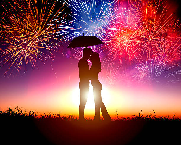 istock Couple kissing under umbrella with firework in the sky 463822237