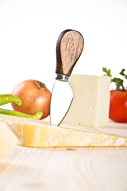 istock Cheese and knife on a wooden table 463834431