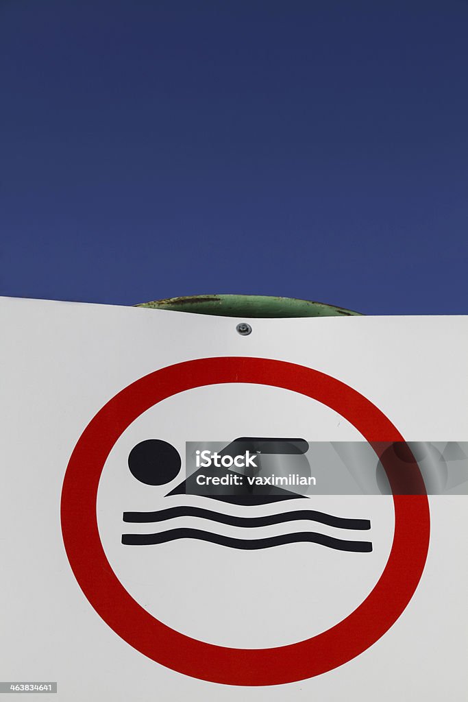 No Swimming sign No swimming sign against blue sky Advice Stock Photo