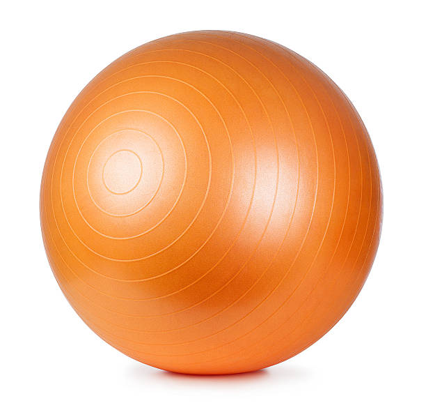 A large orange fitness ball on a white background Close up of an orange fitness ball isolated on white background exercise equipment stock pictures, royalty-free photos & images