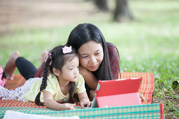 istock Asean mother playing tablet with daughter 463851621