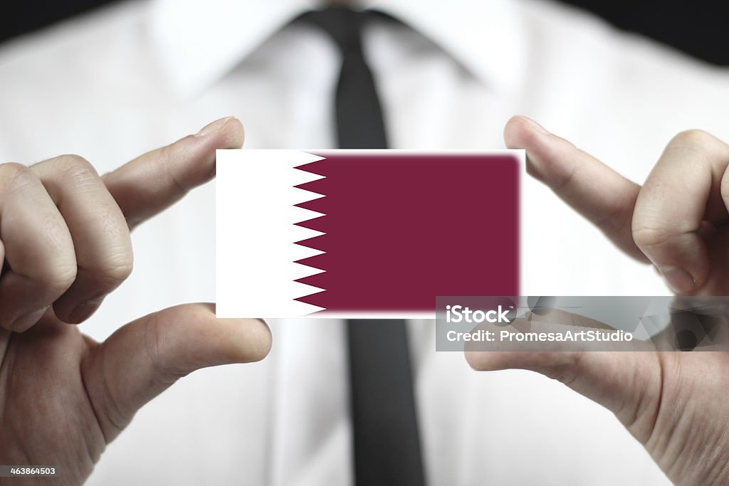 Businessman holding a business card with Qatar Flag Adult Stock Photo