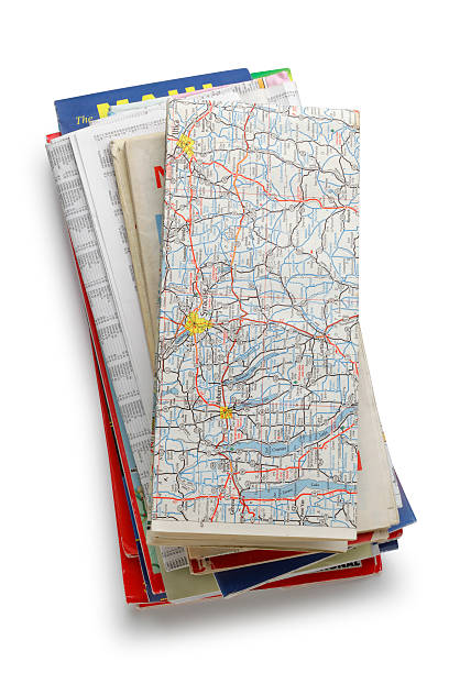 Stack of Road Maps A stack of road maps isolated on white. Clipping path included. attraction studio photography stock pictures, royalty-free photos & images