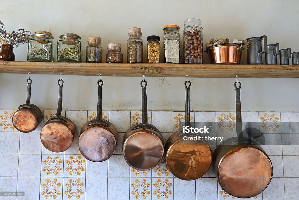 kitchen four Old saucepans hanging from in a traditional-style kitchen Cooking Pan Stock Photo