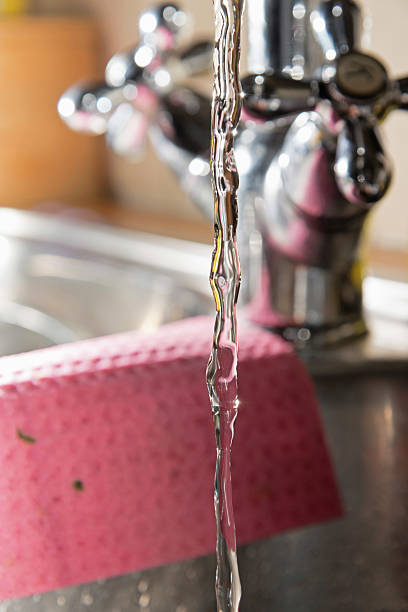 istock Close-up of water stream from classic kitchen tap. 463875159