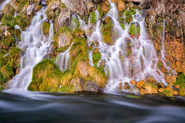 istock Slow water of a spring glides over rocks 463886081