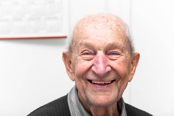 istock Senior man smiling greyscale and color image 463938957