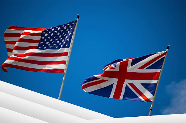 istock U.S. and UK flags in the blue sky 463940785