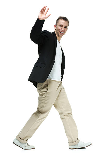 istock Smiling man walking and waving hand 463945755