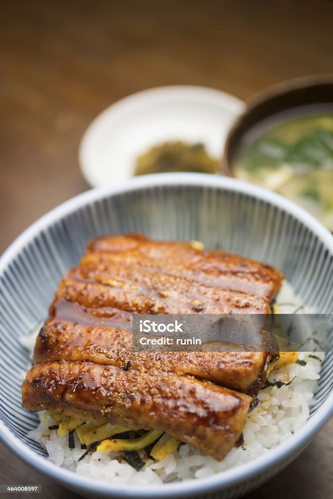 Japanese Cuisine Unadon Unadon (鰻丼, an abbreviation for unagi + donburi, lit. "eel bowl") is a dish originating in Japan. It consists of a donburi type large bowl filled with steamed white rice, and topped with fillets of eel (unagi) grilled in a style known as kabayaki, similar to teriyaki. Abbreviation Stock Photo