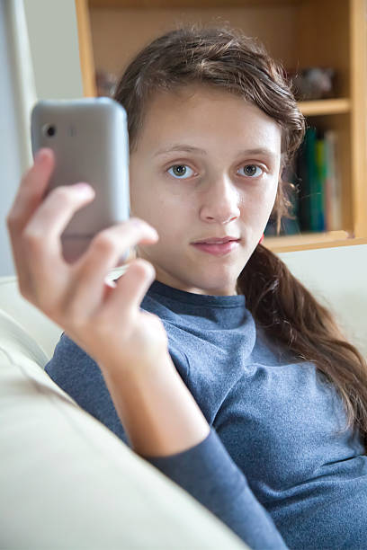 istock girl playiing on mobile 464082539