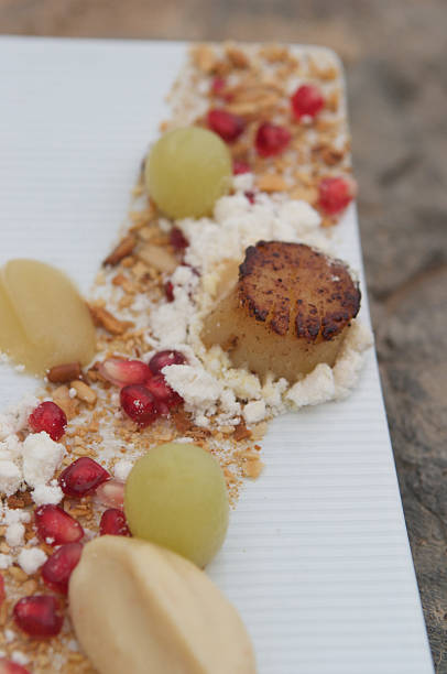 istock Scallops with grape, pomegranate, nut, cauliflower puree & butter powder 464085271