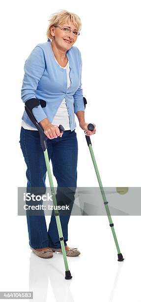 Mature Woman With Crutches Stock Photo - Download Image Now - White Background, Crutch, Women