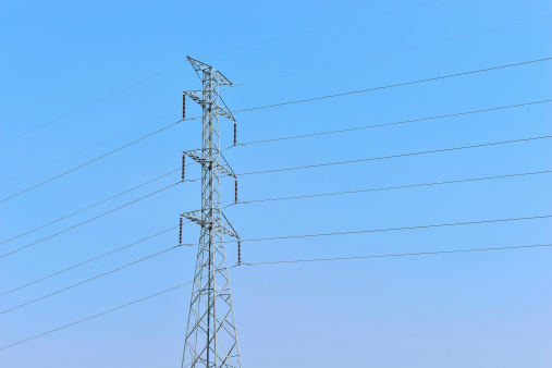 High voltage lines on a background of the blue cloudy sky