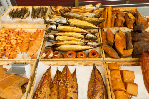 Different kinds of smoked fish and shrimps on the market at the harbor.