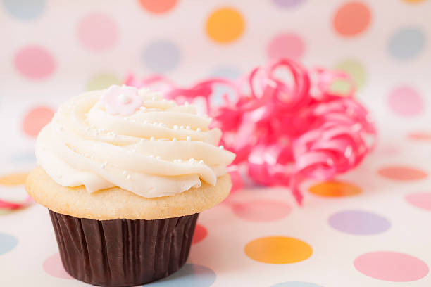 istock Food:  Pastel cupcake with wrapping paper, ribbon background. 464172617