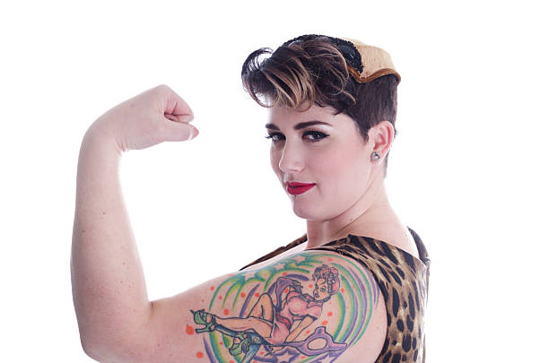 istock Strong confident tattooed woman flexing arm. 464175531