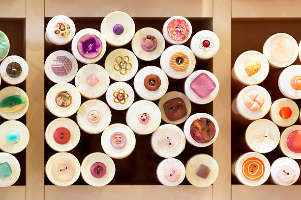 istock Closeup colourful sawing buttons display on wooden shelfs 464175597