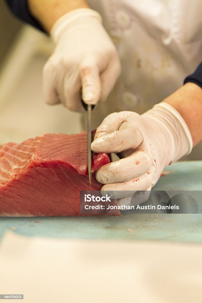 Cutting Blocks of Tuna Sashimi Cutting slabs of raw tuna for sashimi. Block Shape Stock Photo