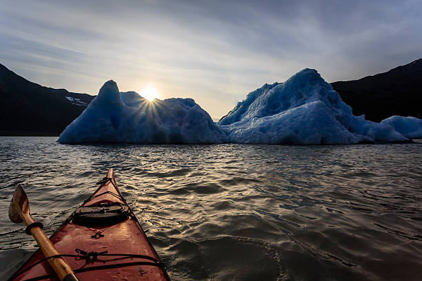 istock Kayak and iceberg at sunset 464193997