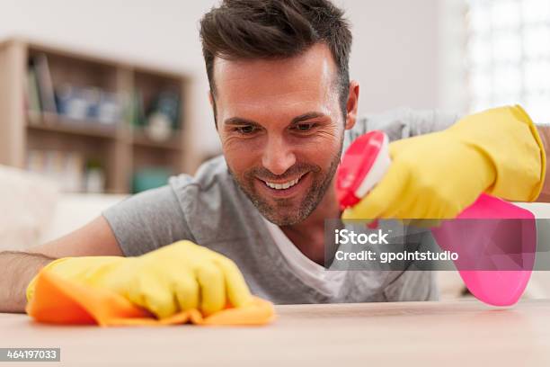 Smiling Man Cleaning Desk In Living Room Stock Photo - Download Image Now - Adult, Adults Only, Beard