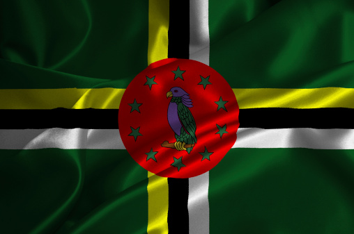 Dominica flag on satin texture.