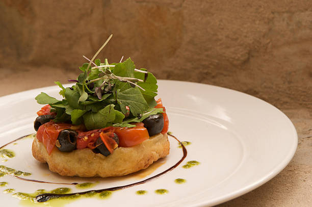 istock Tomato, olive tarte tatin, balsamic syrup & rocket pesto. 464205731