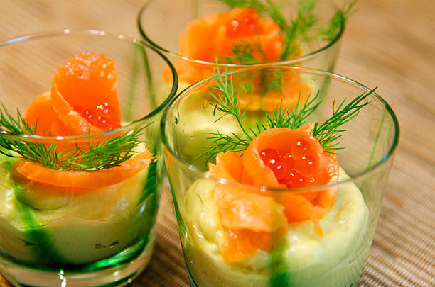 salmon and red cavian over avocado mousse stock photo