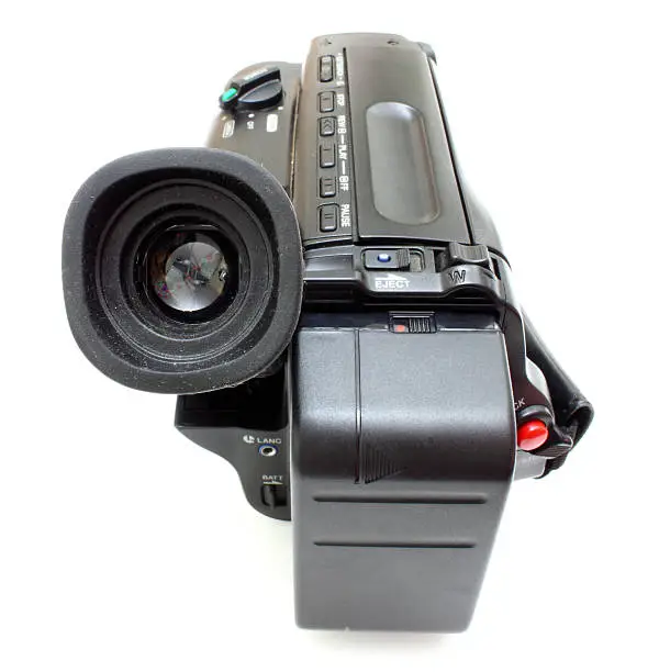 Black videocamera with buttons and switches on a white background