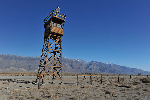 istock Wooden guard tower in desert by mountains 464218541